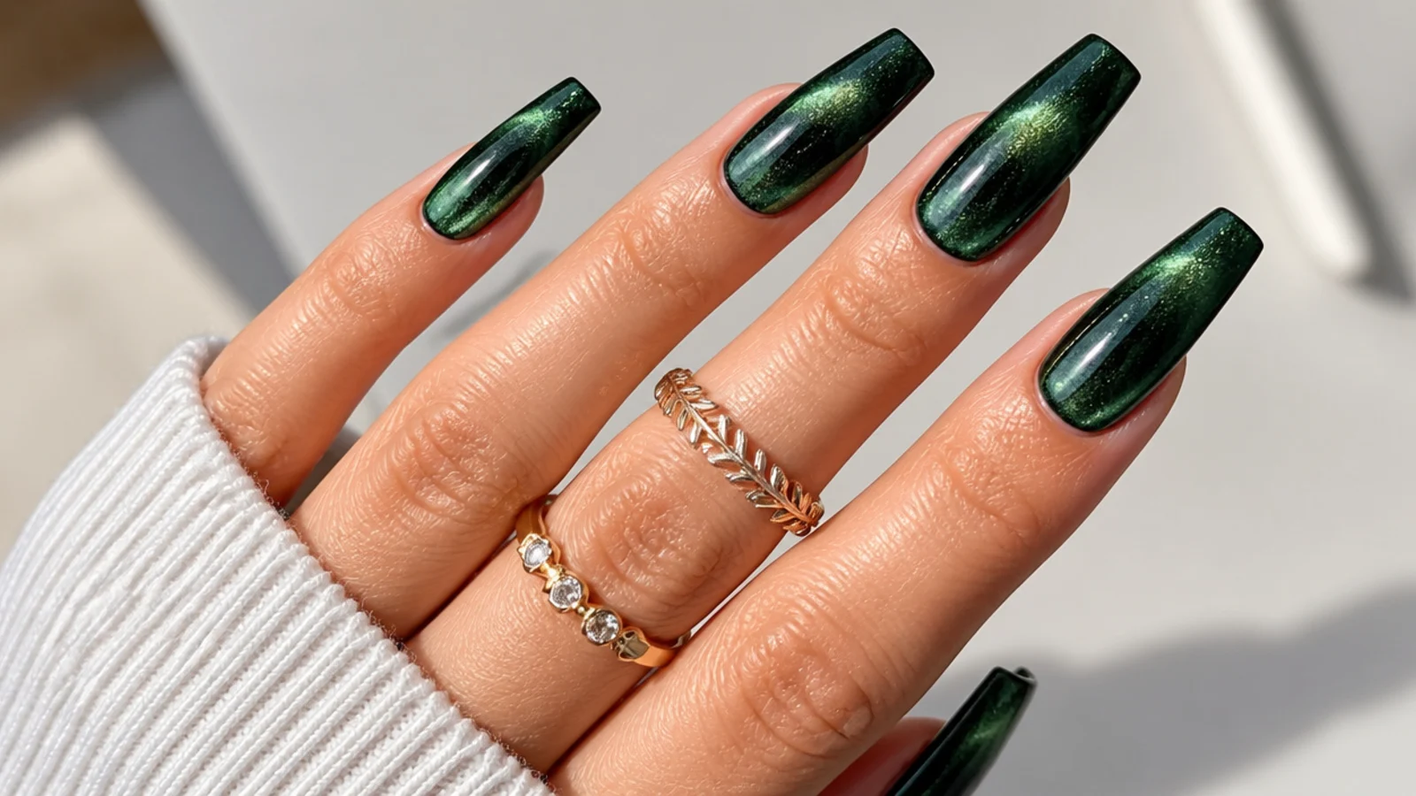 Deep green magnetic cat-eye acrylic nails on a coffin shape