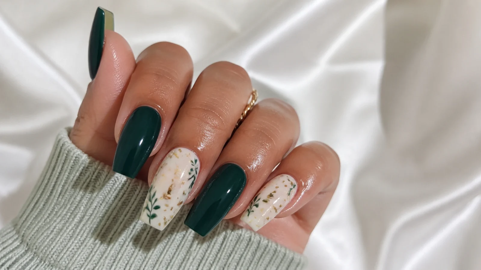 A well-sealed dark green acrylic set with cuticle oil for longevity