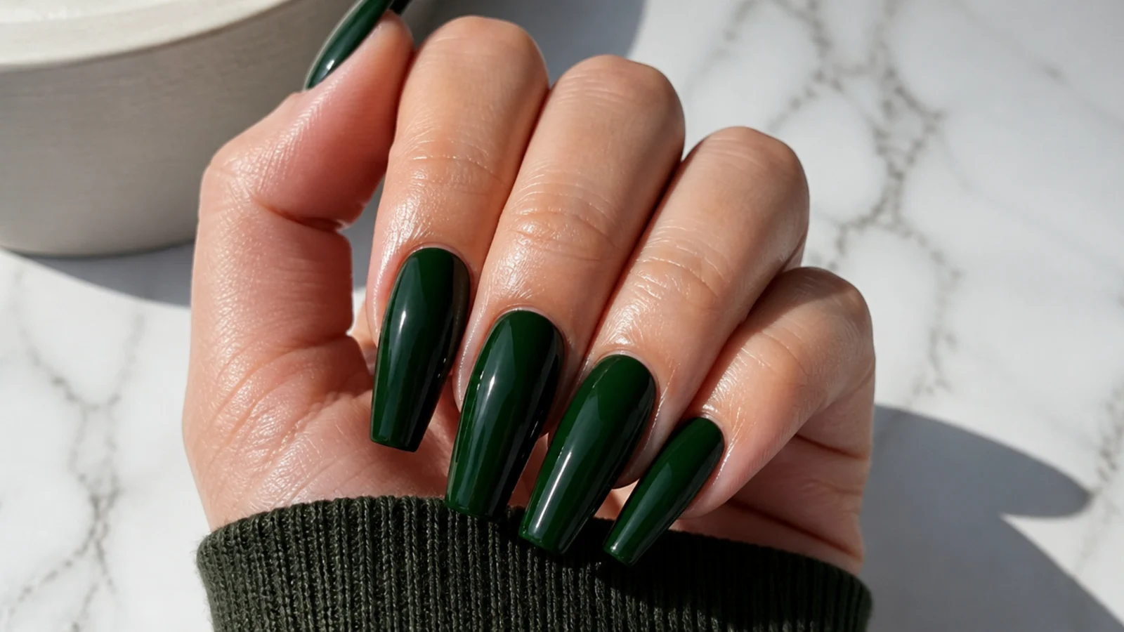 Long glossy dark green coffin nails with a deep bottle-green shine