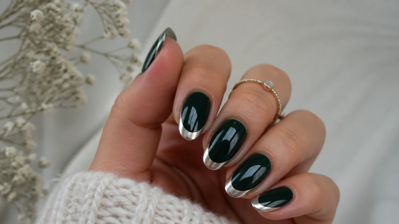Dark emerald nails with reflective silver chrome french tips