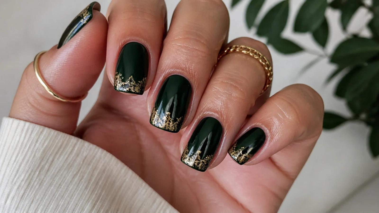 A well-sealed dark green gel manicure with cuticle oil for longevity