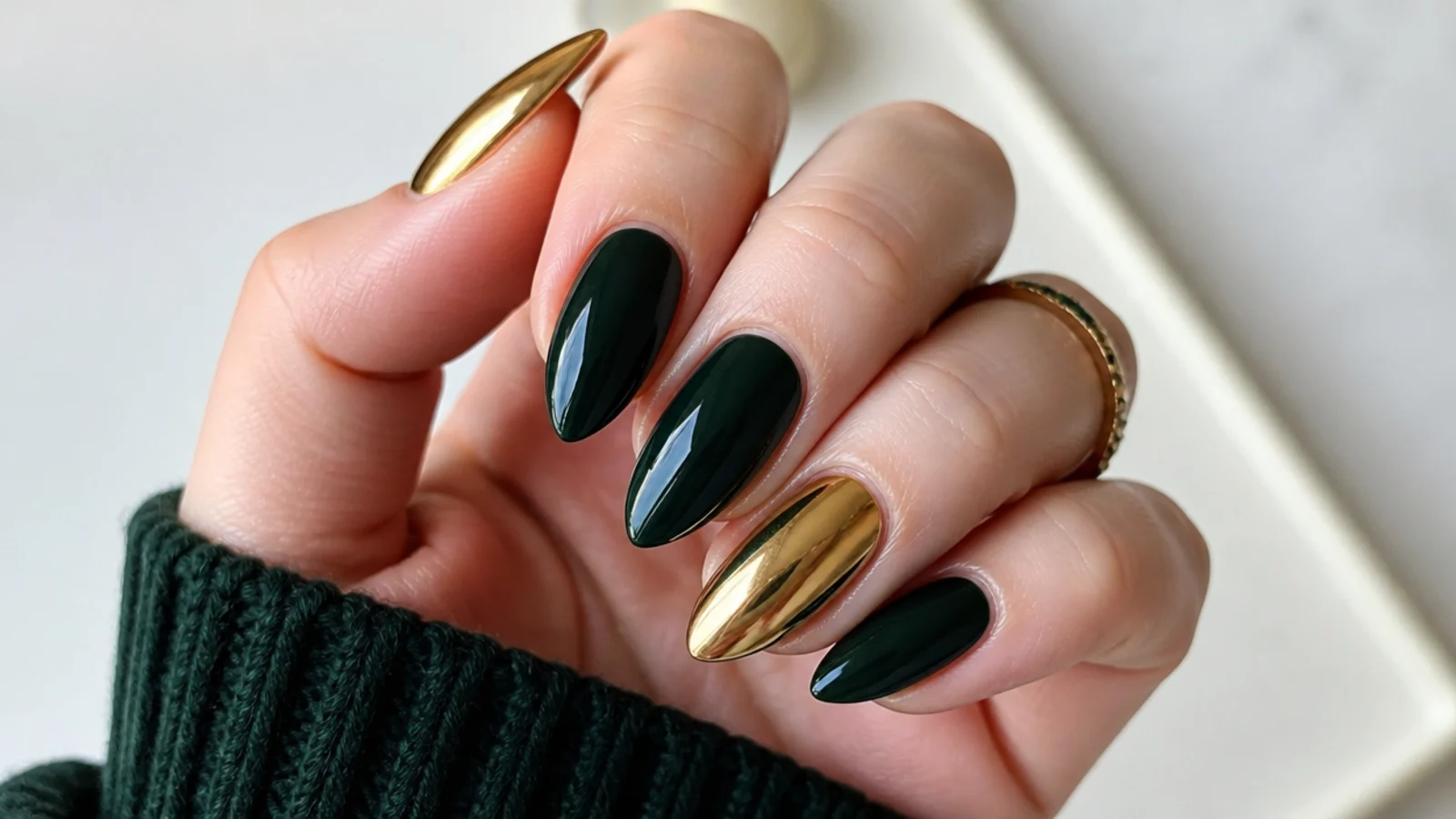 Dark emerald almond nails with gold chrome accent nails