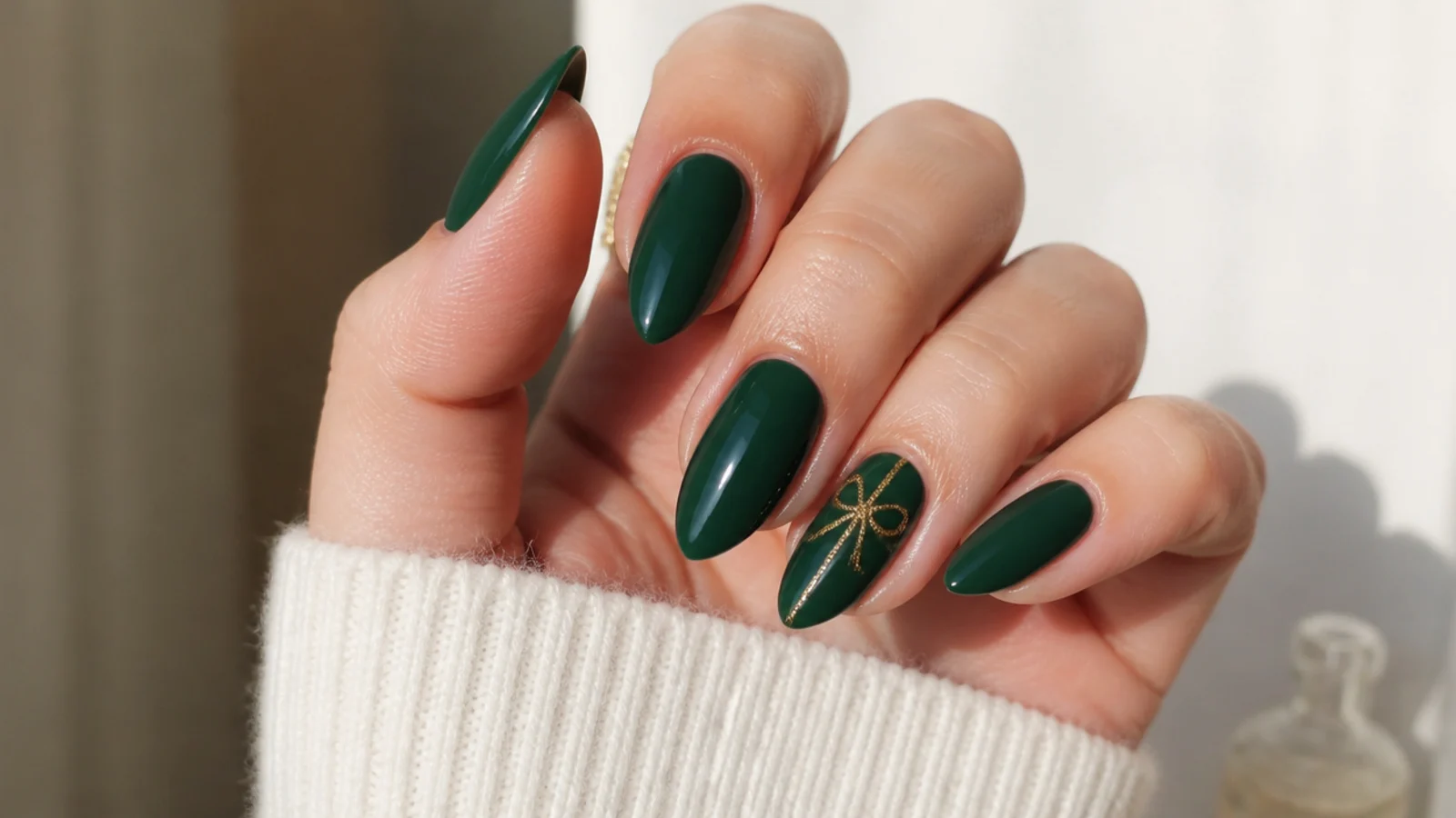 A well-sealed dark green almond manicure with cuticle oil