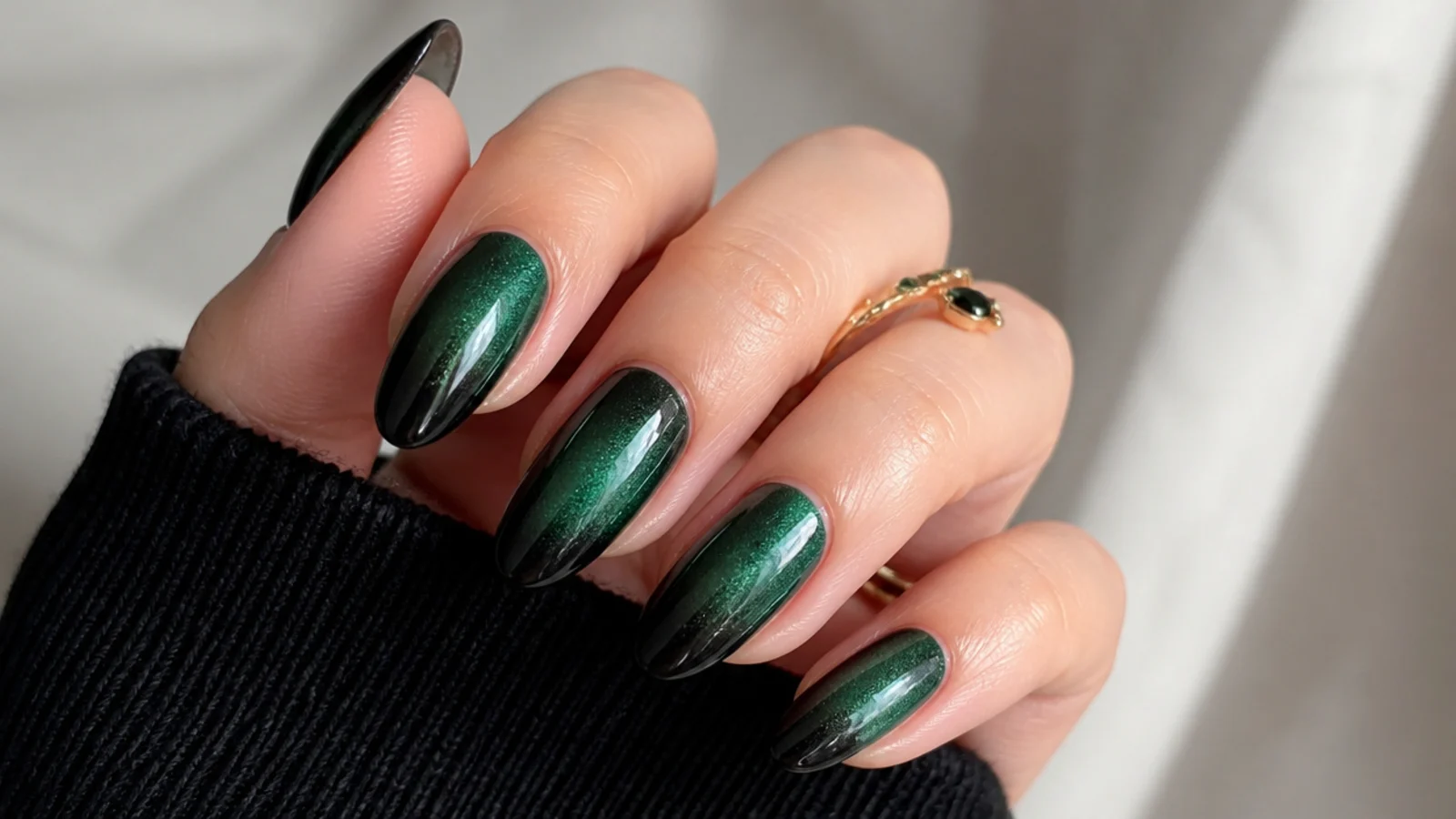 Smoky emerald green fading into black ombre nails