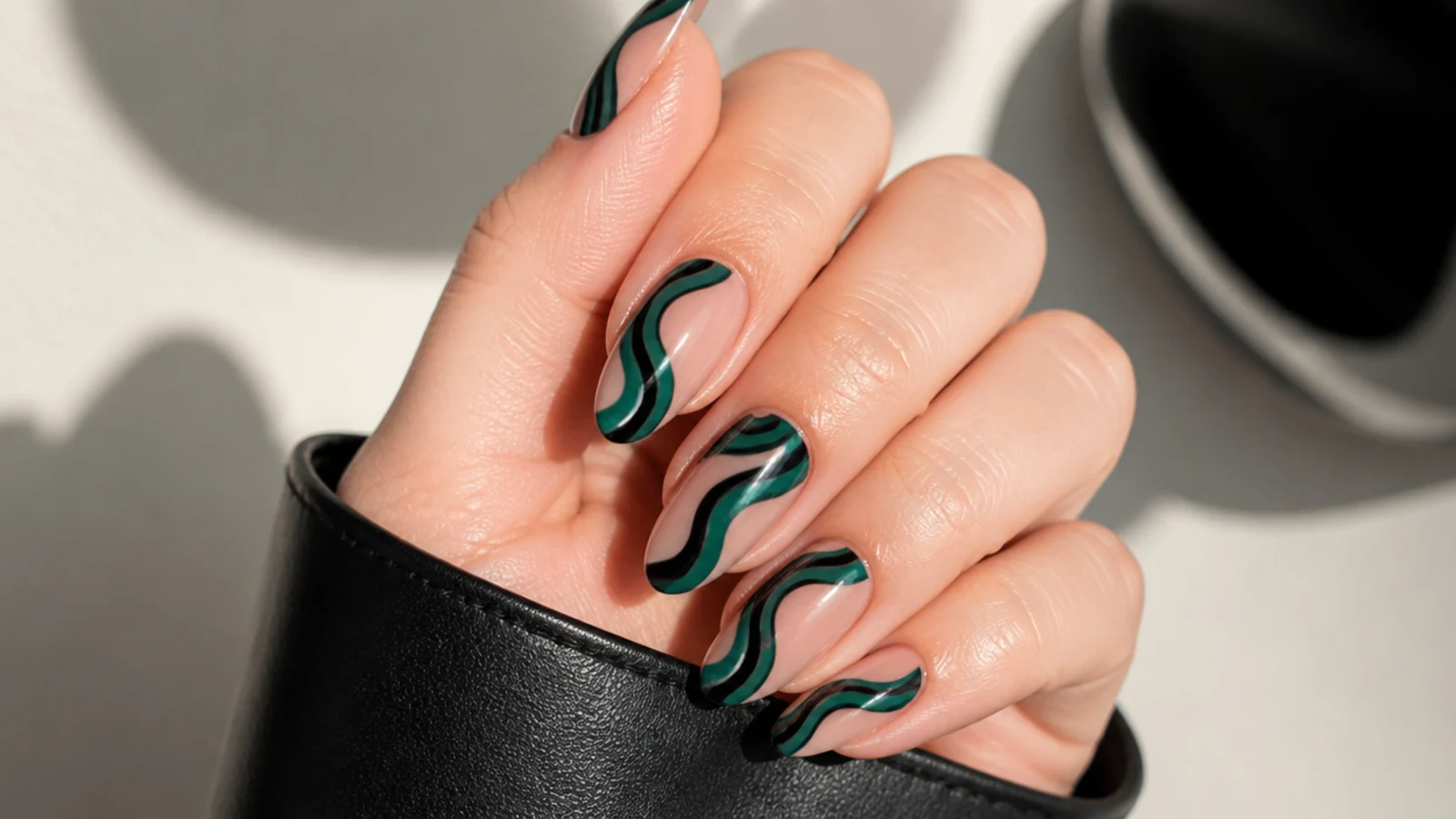 Retro emerald green and black swirl nails on a nude base