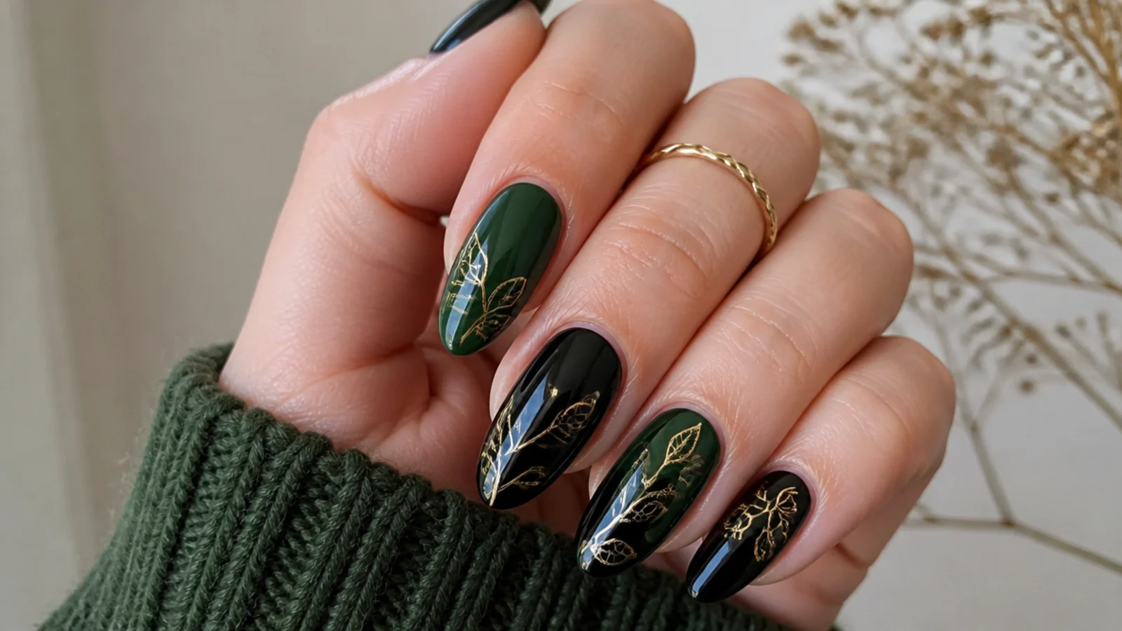 Forest green and black nails with fine gold botanical leaf line art