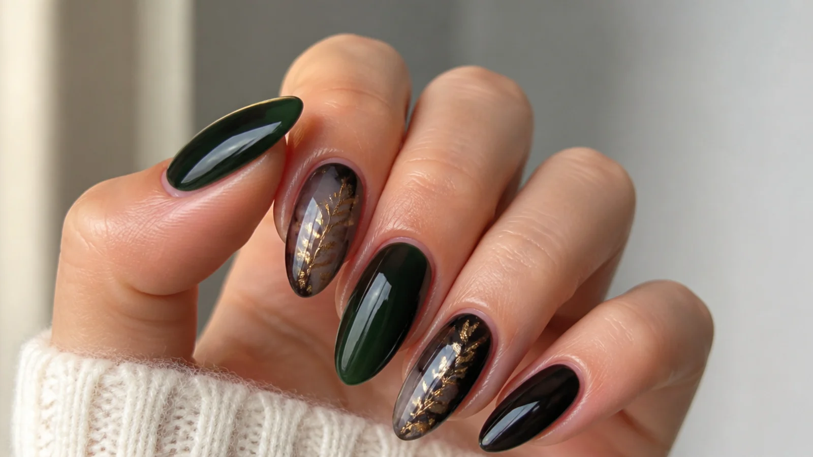 A sealed dark green and black gel manicure with cuticle oil for longevity