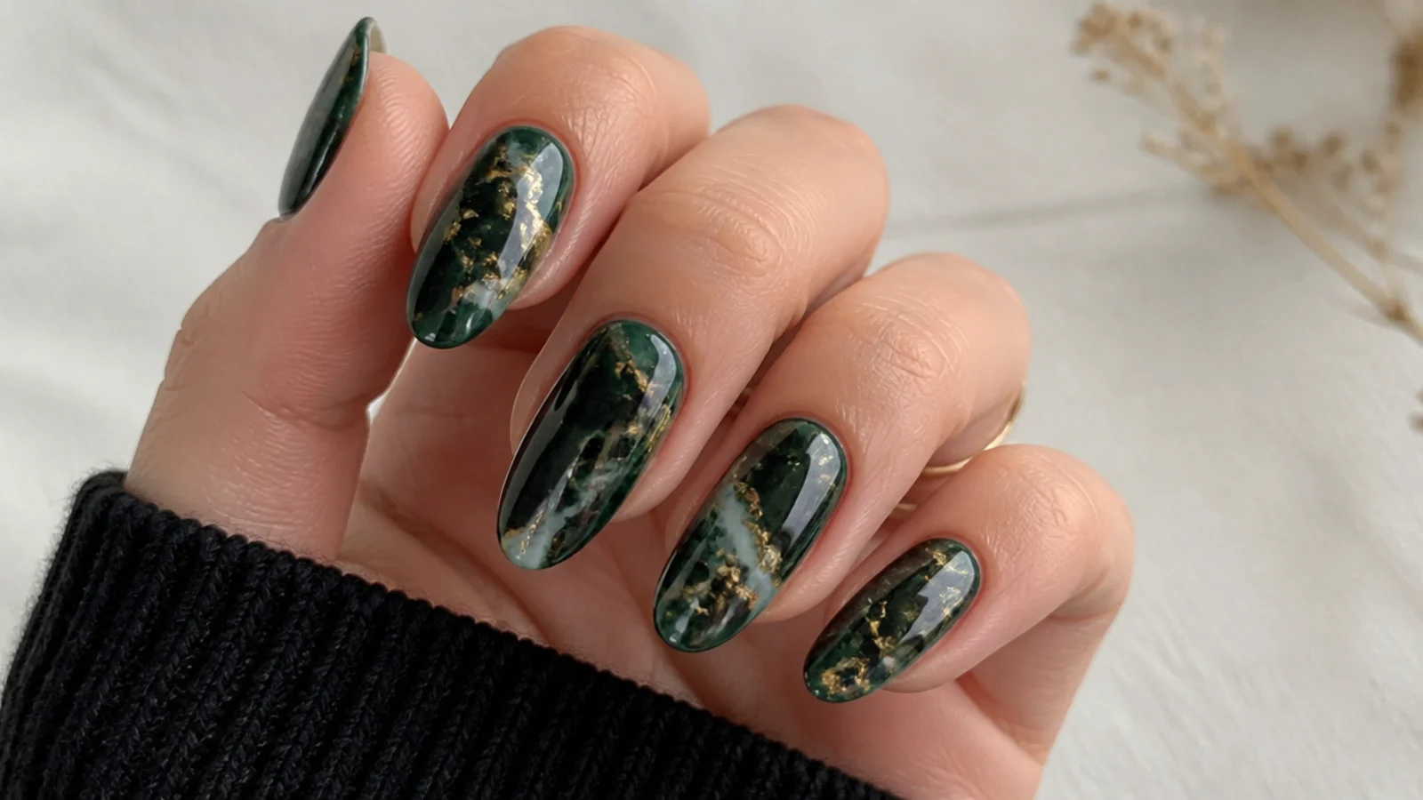 Deep green and black marble nails veined with gold flakes