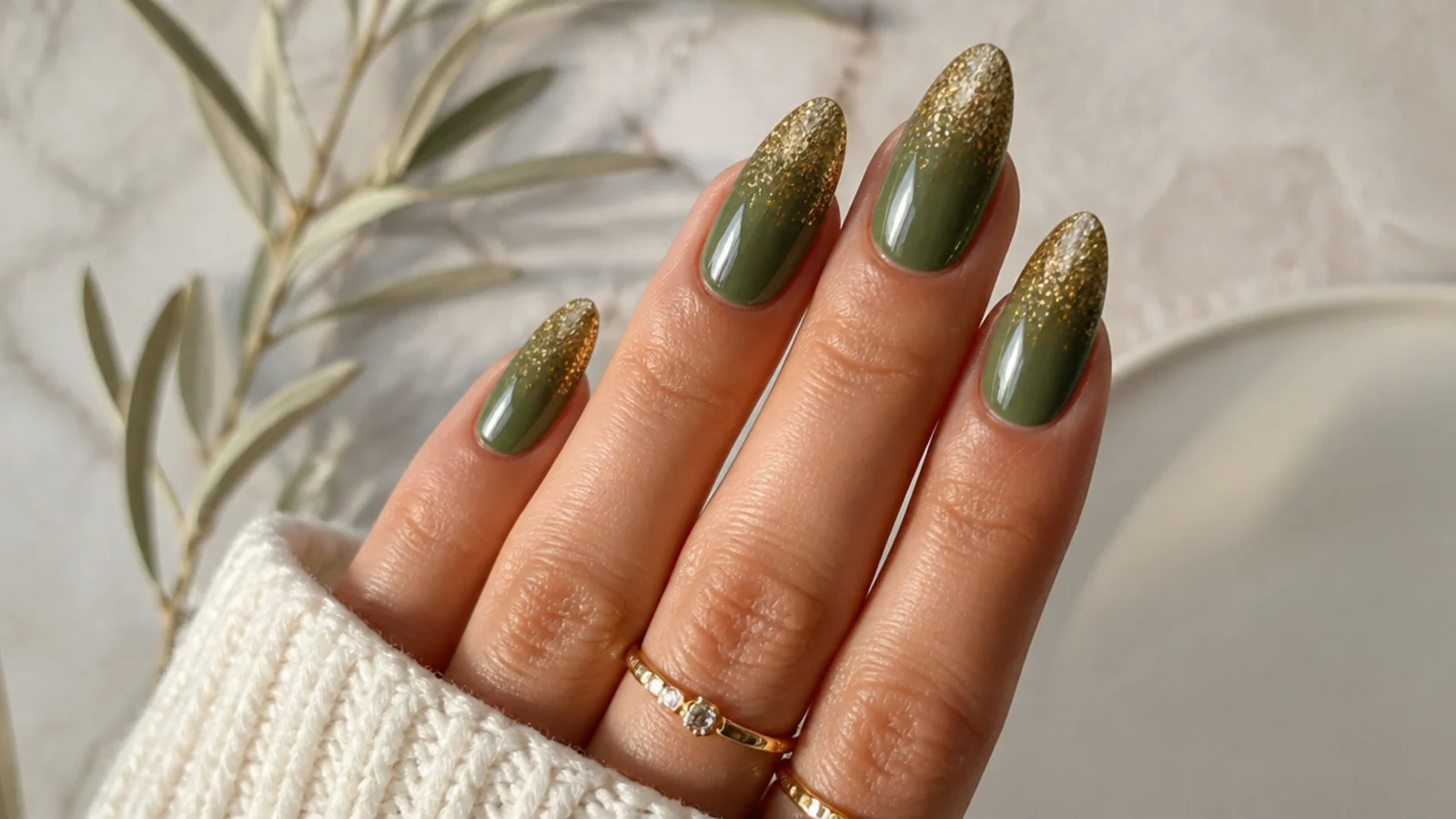 Warm olive green nails fading into gold glitter at the tips