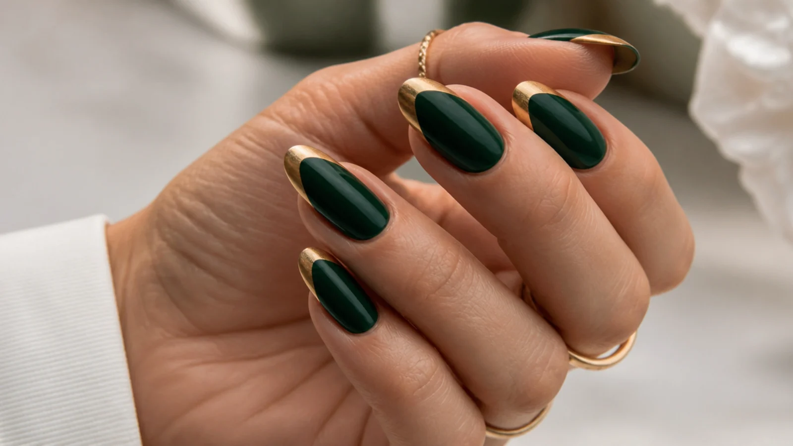 Emerald green nails with metallic gold french tips