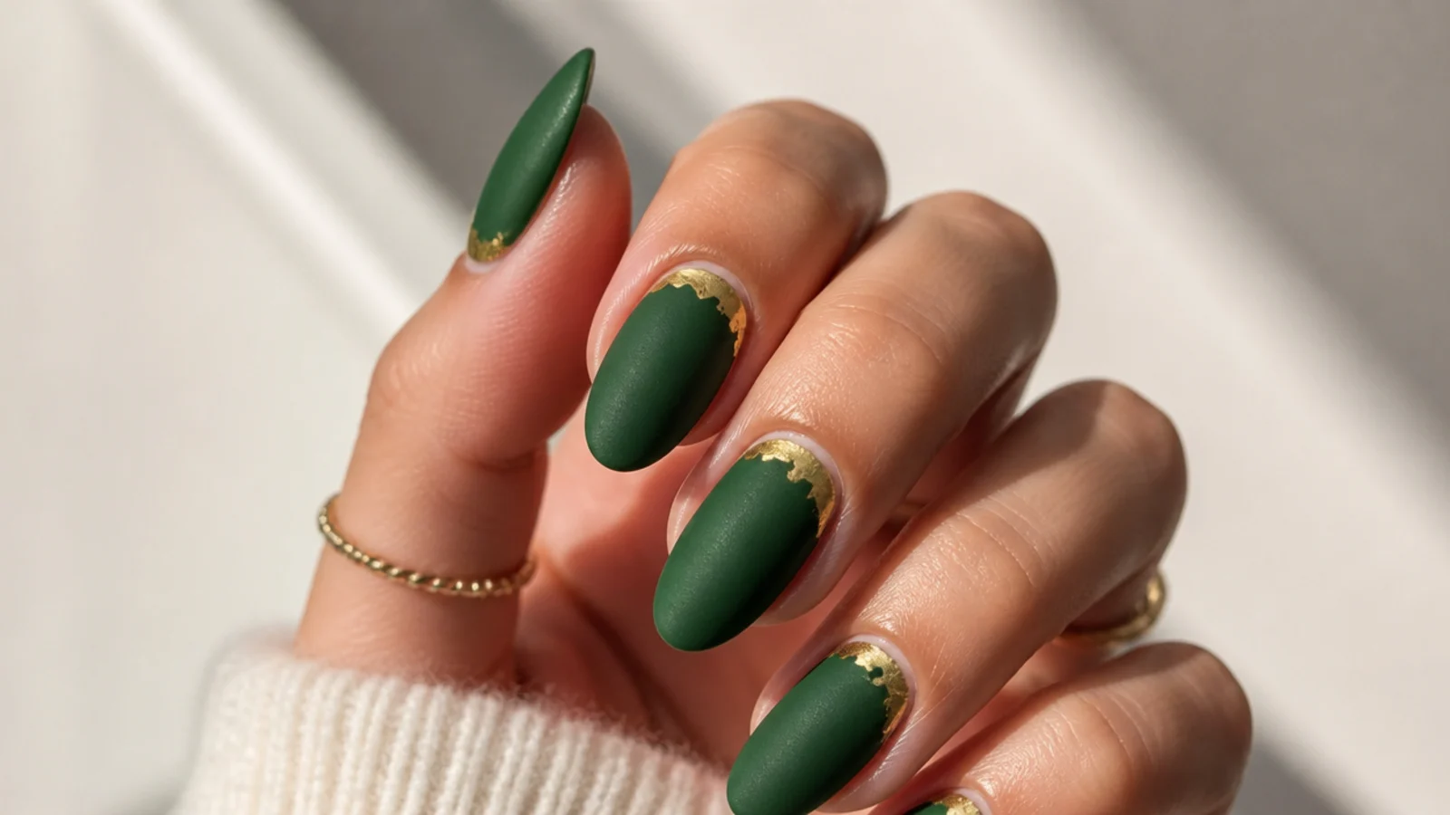 Matte velvet emerald nails with gold foil at the cuticle
