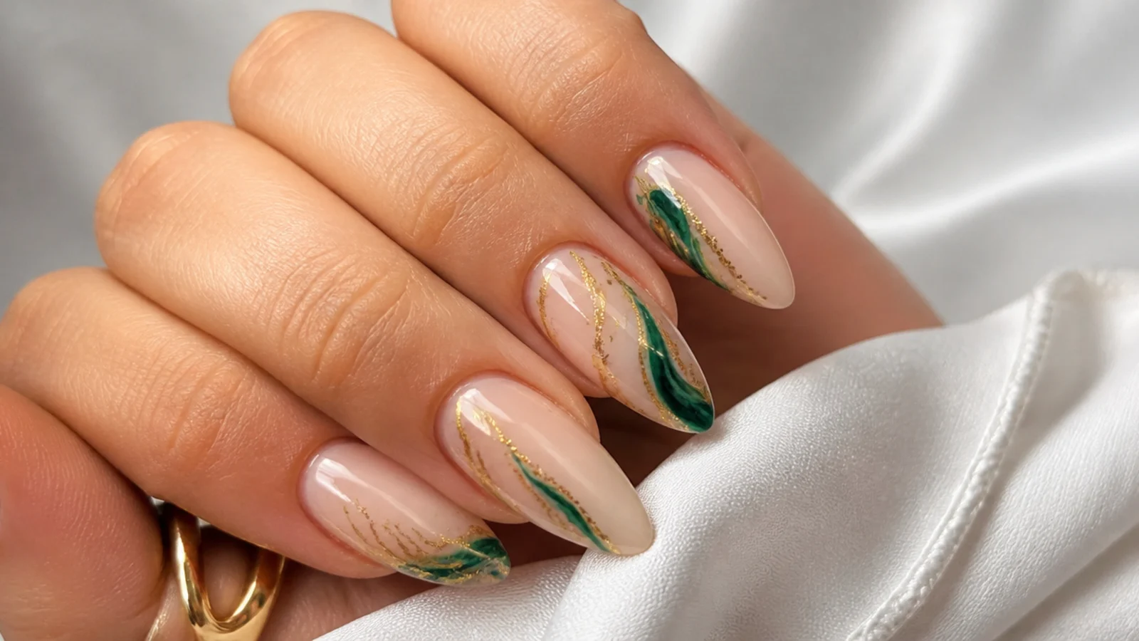 Nude nails with emerald and gold abstract swirls