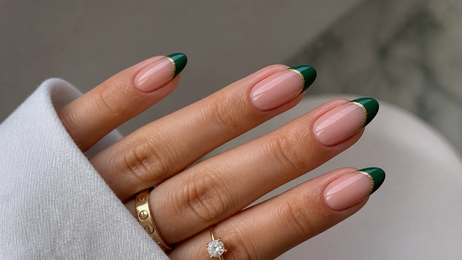 Nude nails with emerald green french tips lined in gold