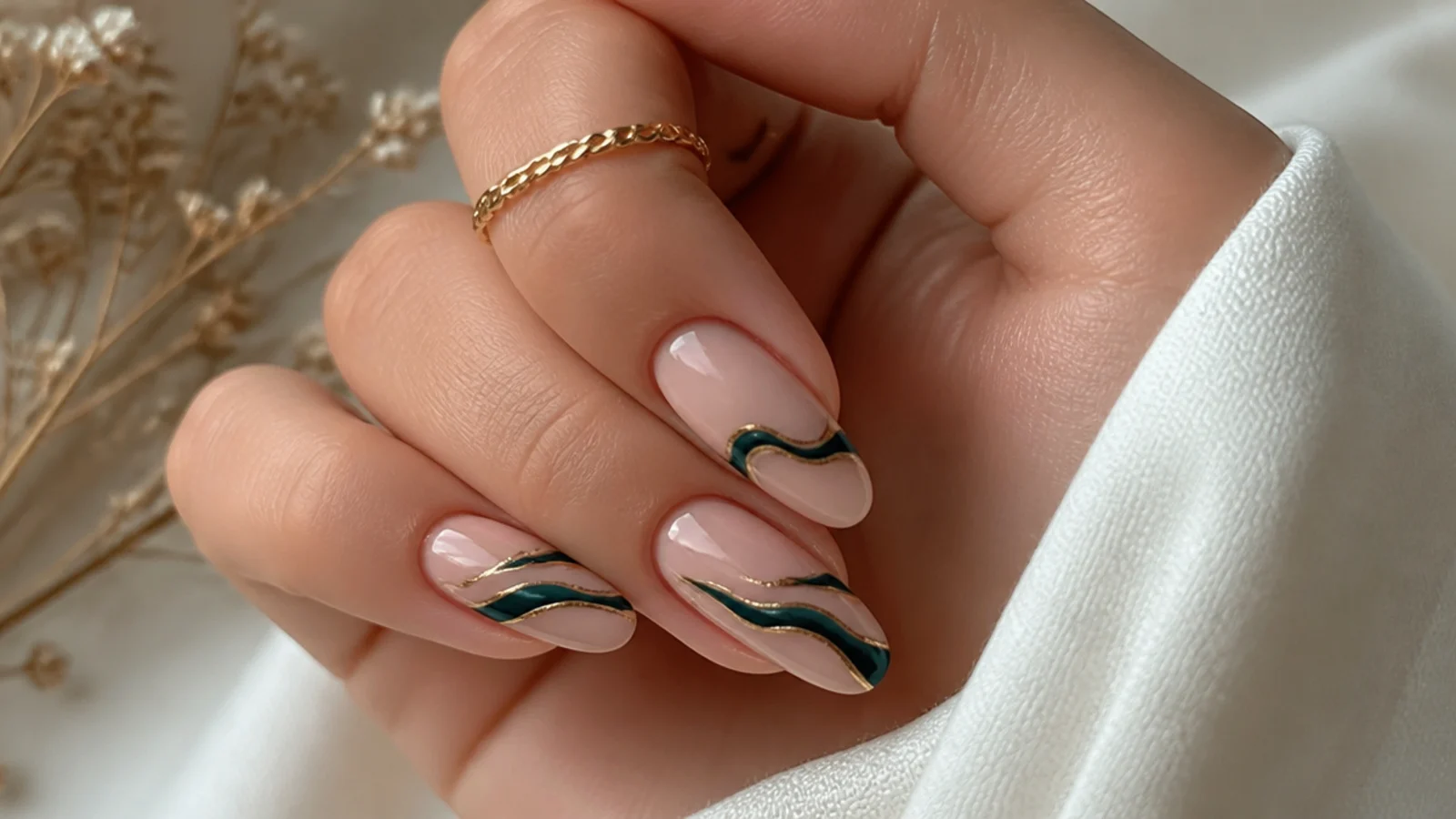 Nude nails with emerald and gold abstract swirl lines