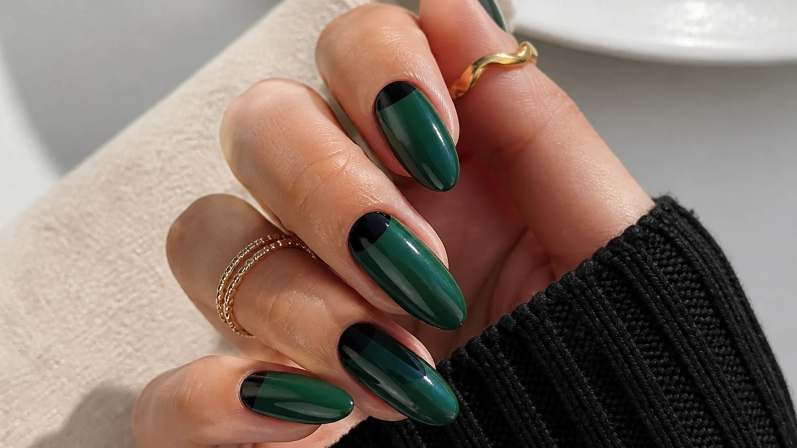 Emerald green nails with black half-moon cuticle accents