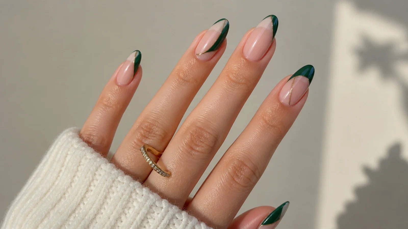 Sheer nails with emerald green geometric shapes and negative space
