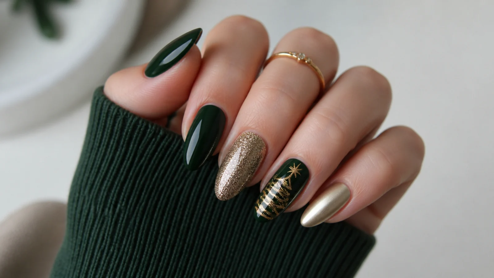 Festive dark green and gold nails styled for a holiday party
