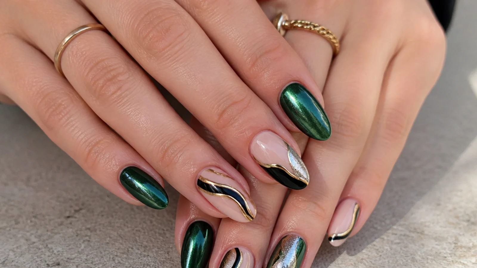 Dark green chrome nails paired with gold, silver, black and nude accents