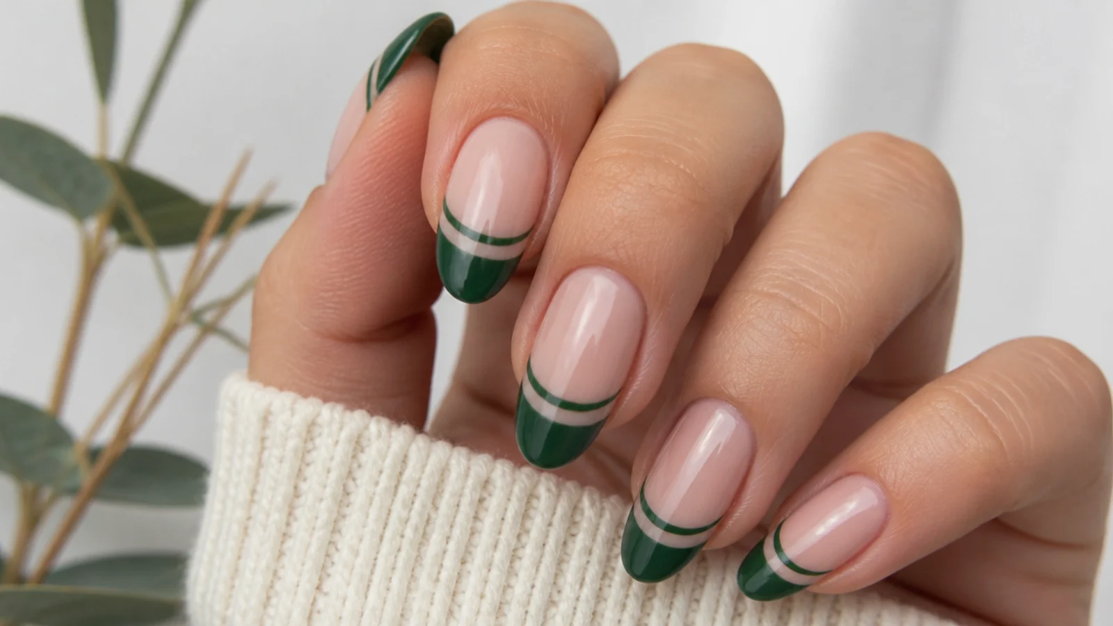 Emerald green tip with a bare negative-space stripe below the smile line on nude nails