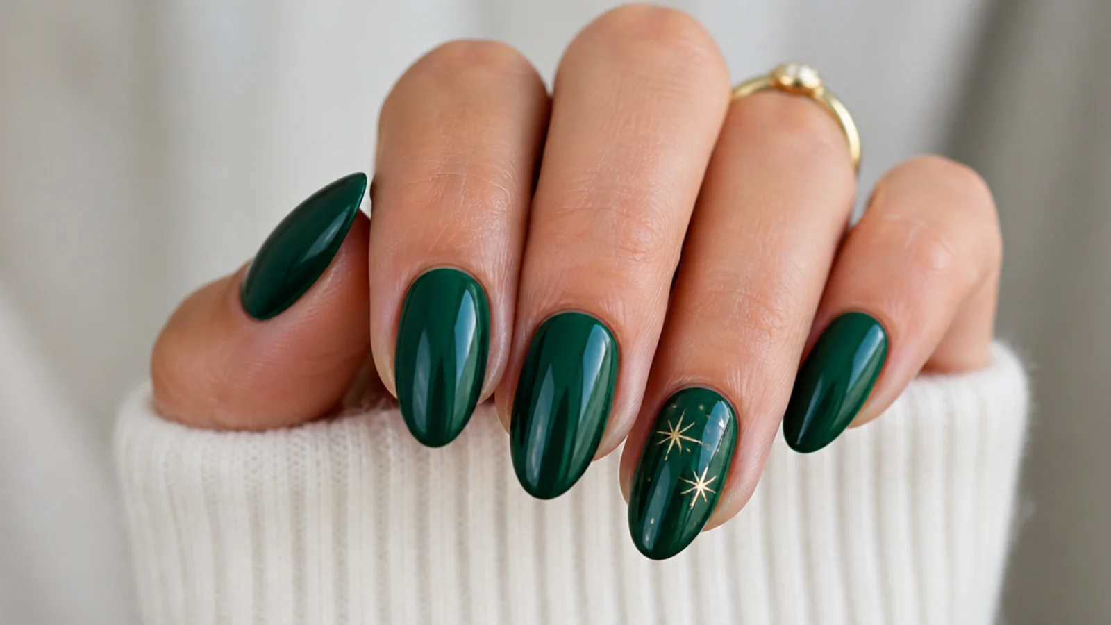 Deep glossy emerald green nails on a medium almond shape