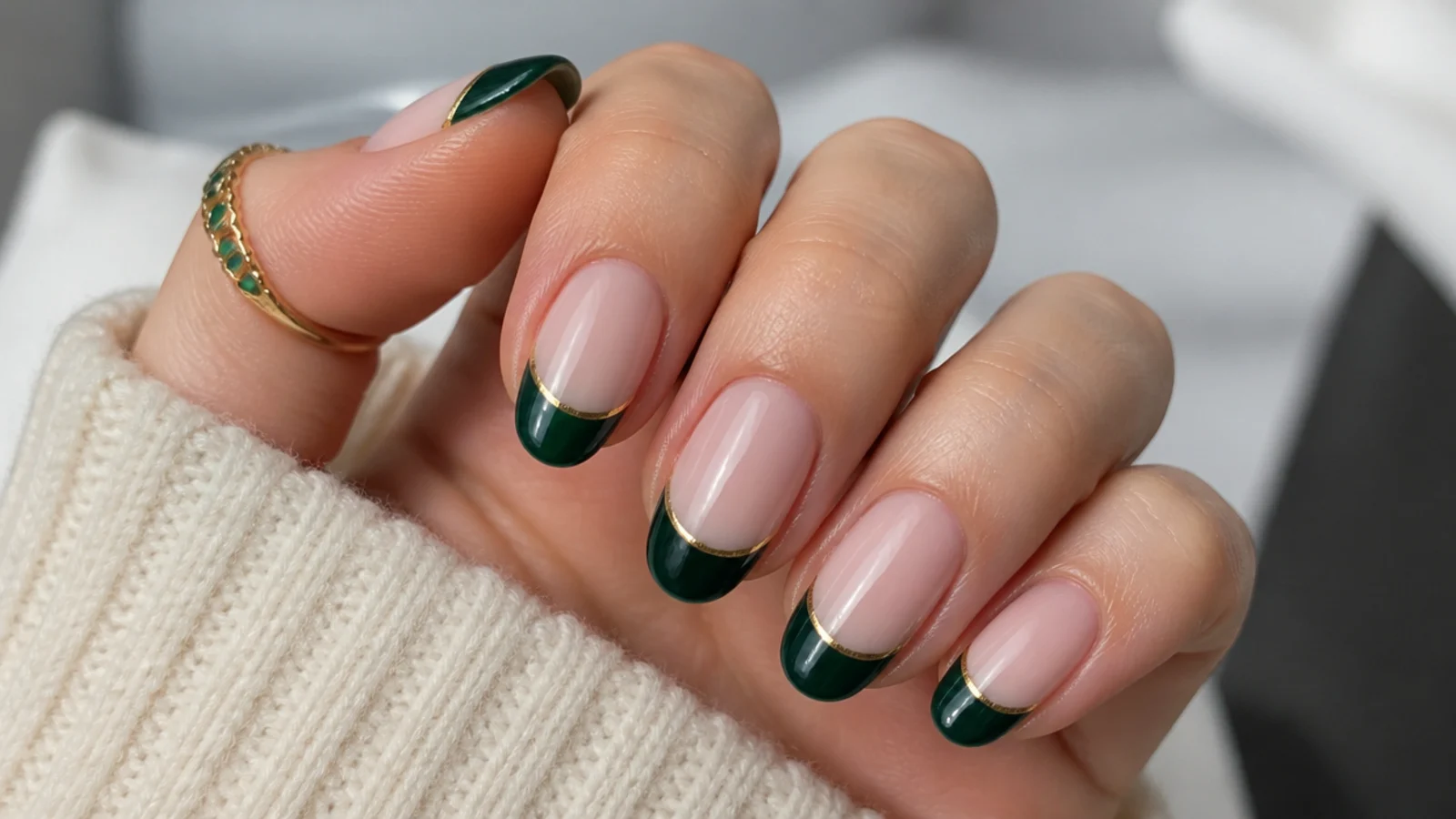 Emerald green french tip nails with thin gold line accents