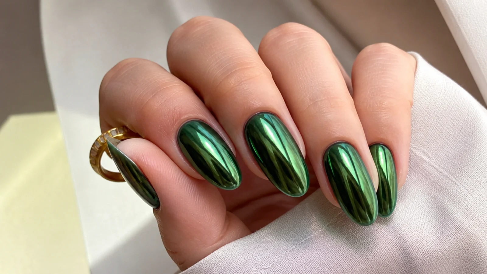 Reflective dark green chrome nails with a mirror metallic finish