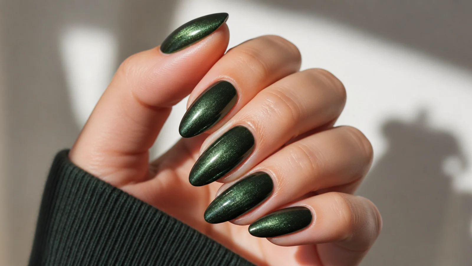 Almond nails in deep forest green velvet cat-eye with a soft brushed sheen