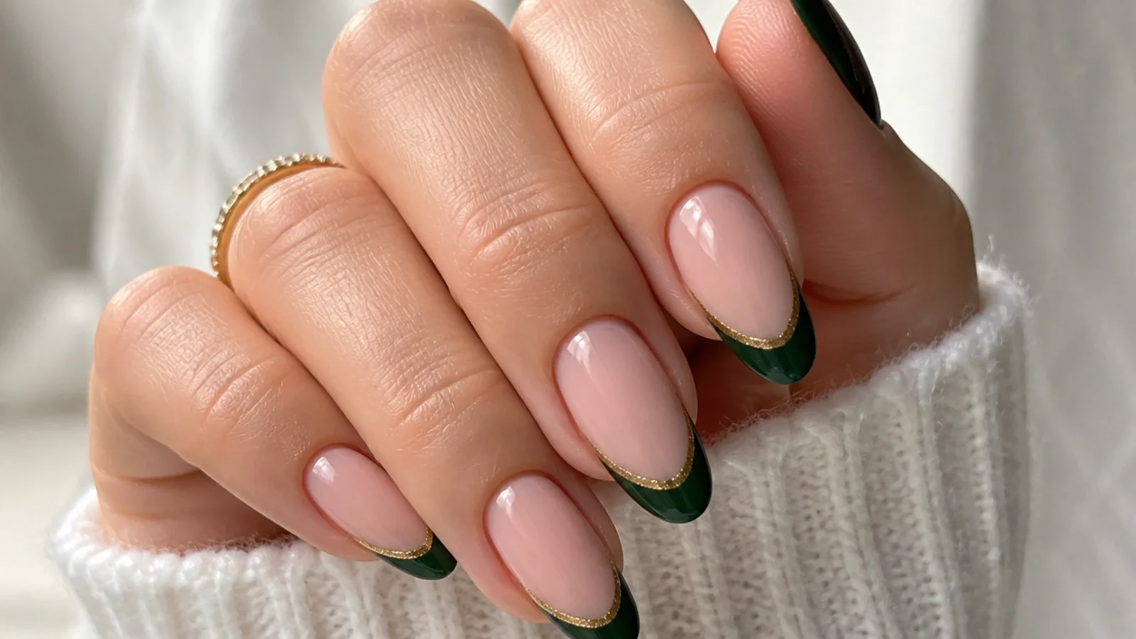 Nude nails with deep emerald french tips lined in thin gold
