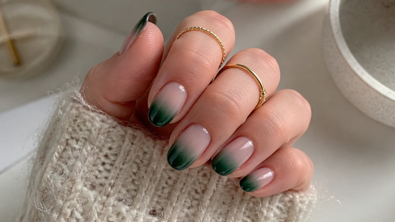 Nails fading from nude at the cuticle to deep green at the tip