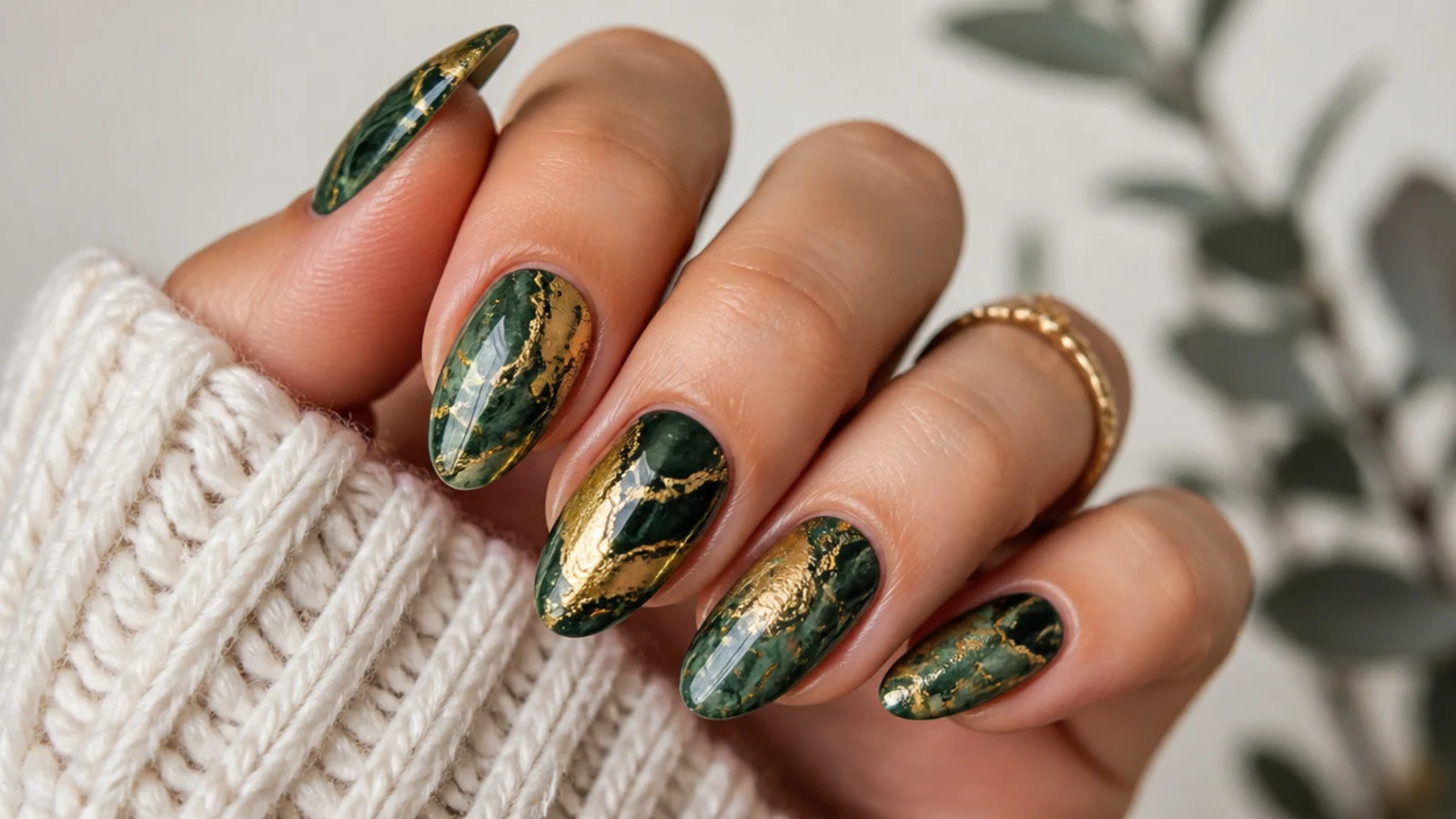 Deep emerald and gold marble swirl nails with veining
