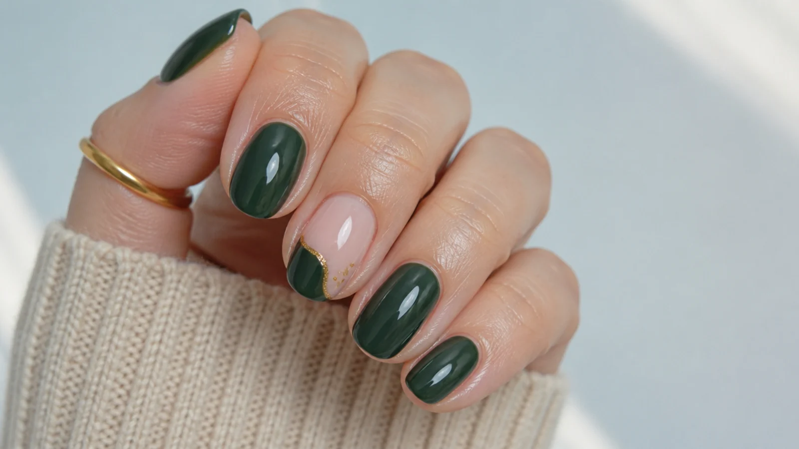 A well-sealed dark green gel manicure with cuticle oil for longevity