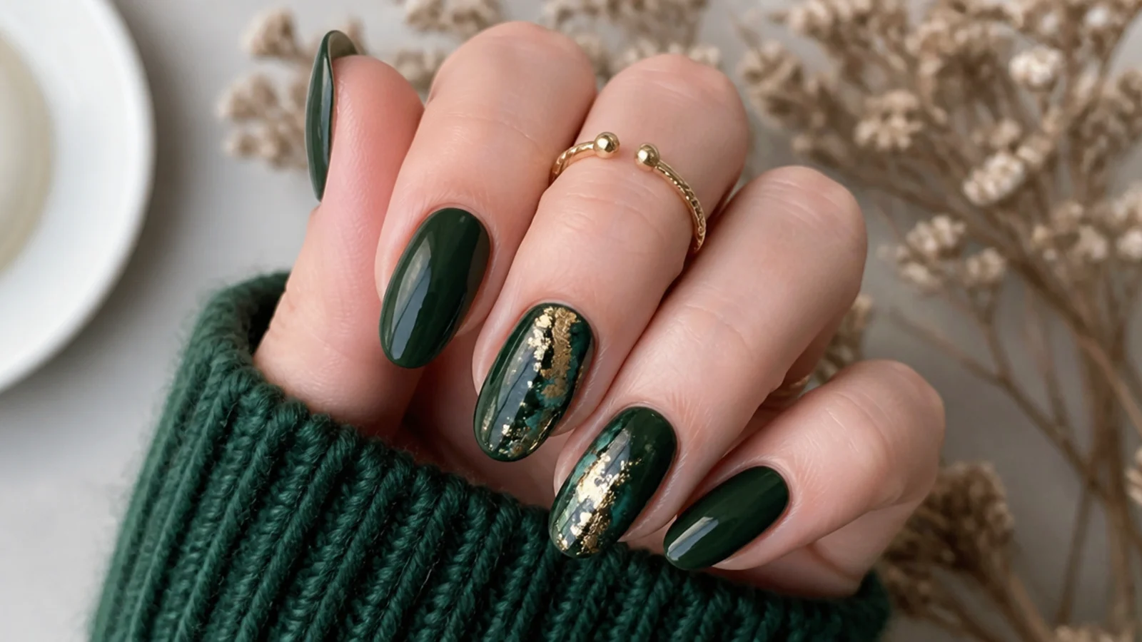 Dark green nails styled for fall, winter and holiday occasions