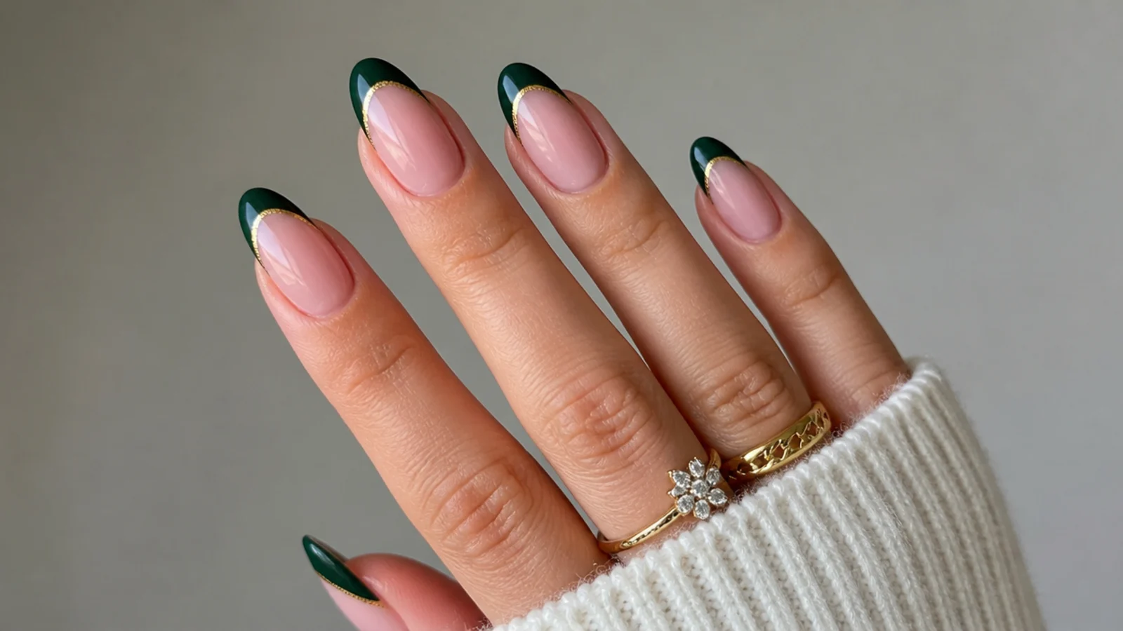 Nude nails with dark green french tips lined in fine gold