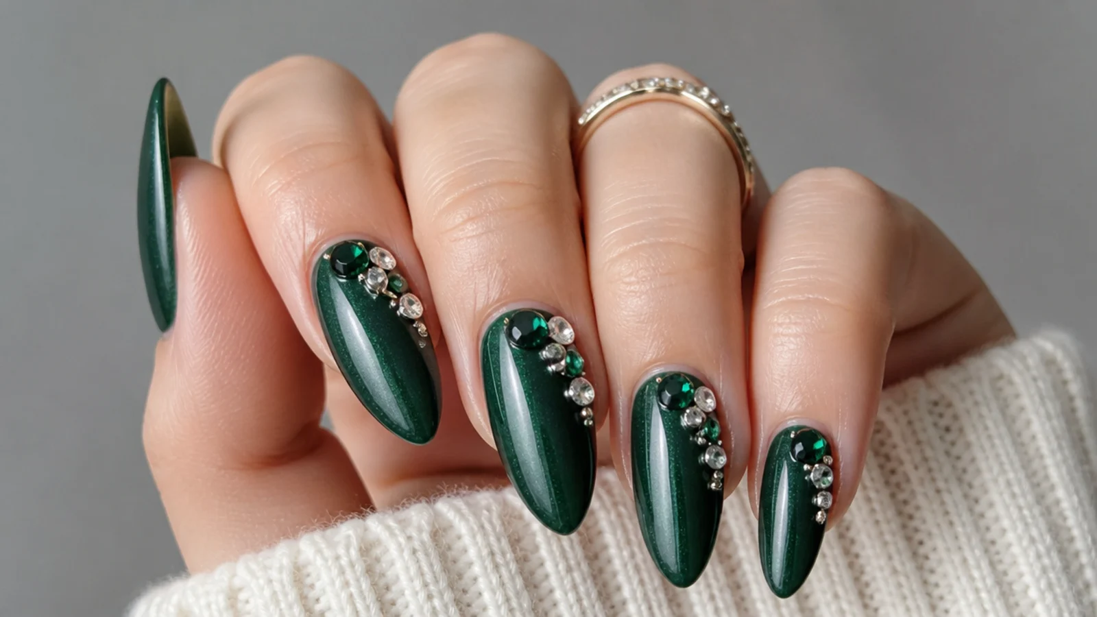 Emerald green nails with clustered clear and green rhinestones