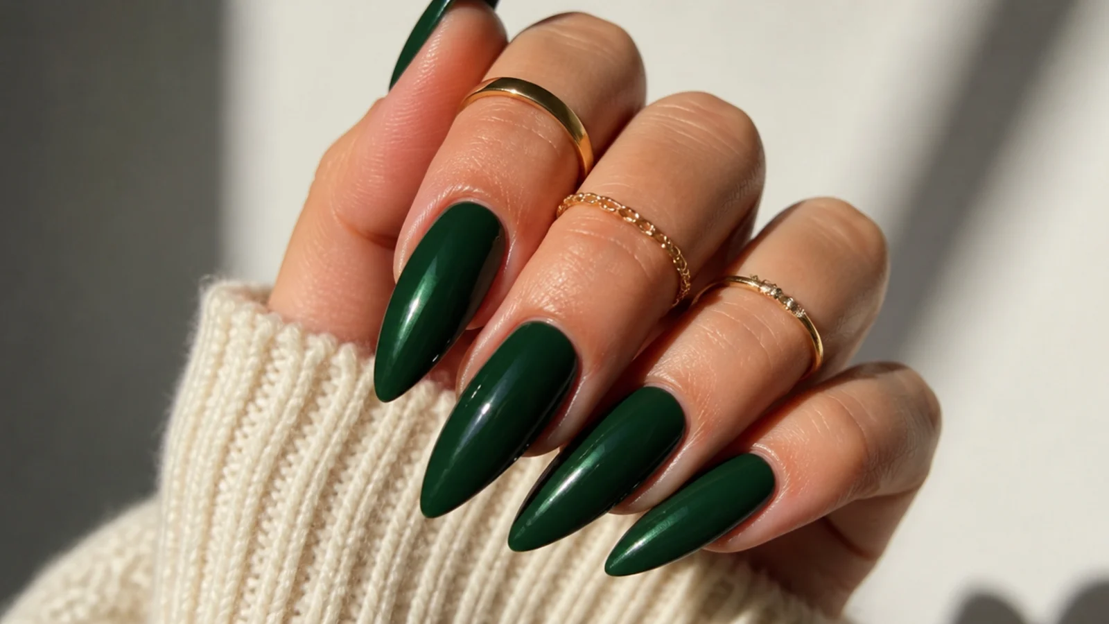 Long forest green stiletto nails with a high-gloss finish