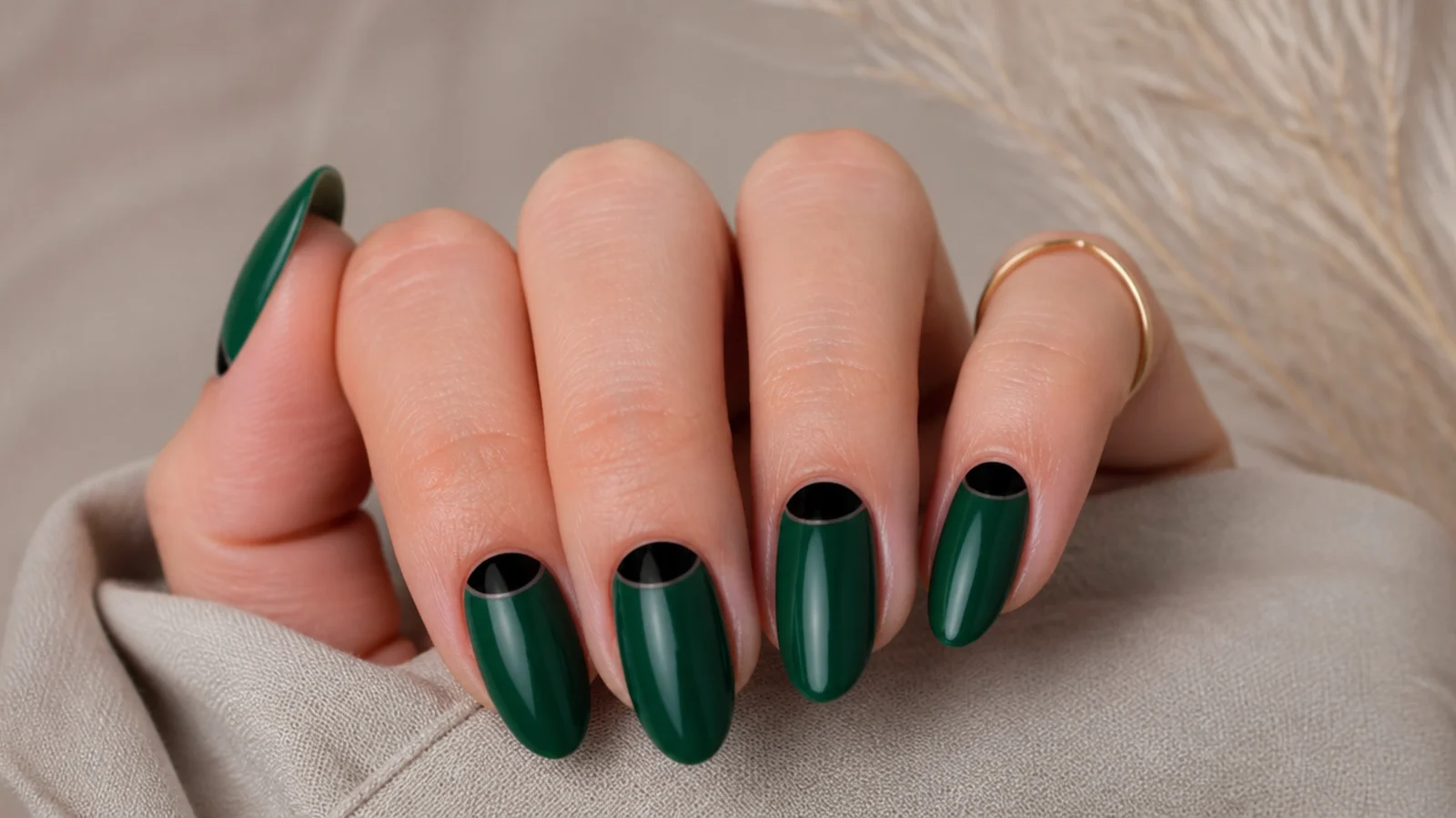 Emerald green nails with glossy black half-moon cuticle accents