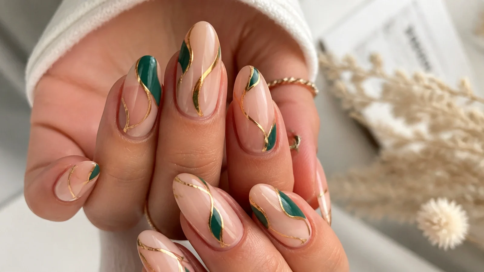 Nude nails with abstract emerald and gold swirl line art