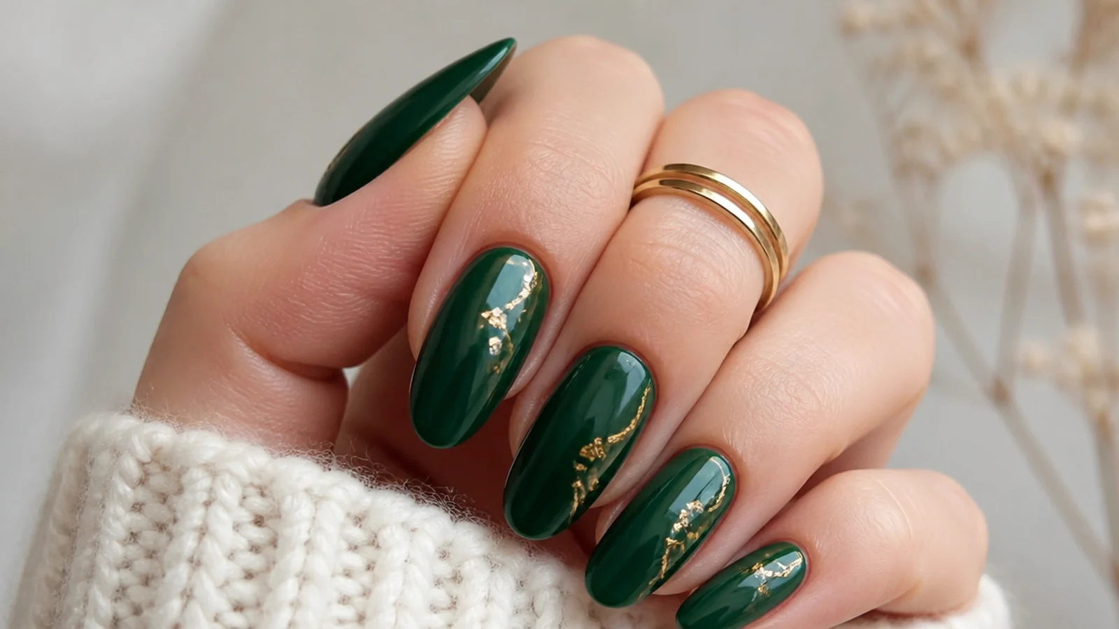 Deep emerald green prom nails on almond shape with fine gold accents