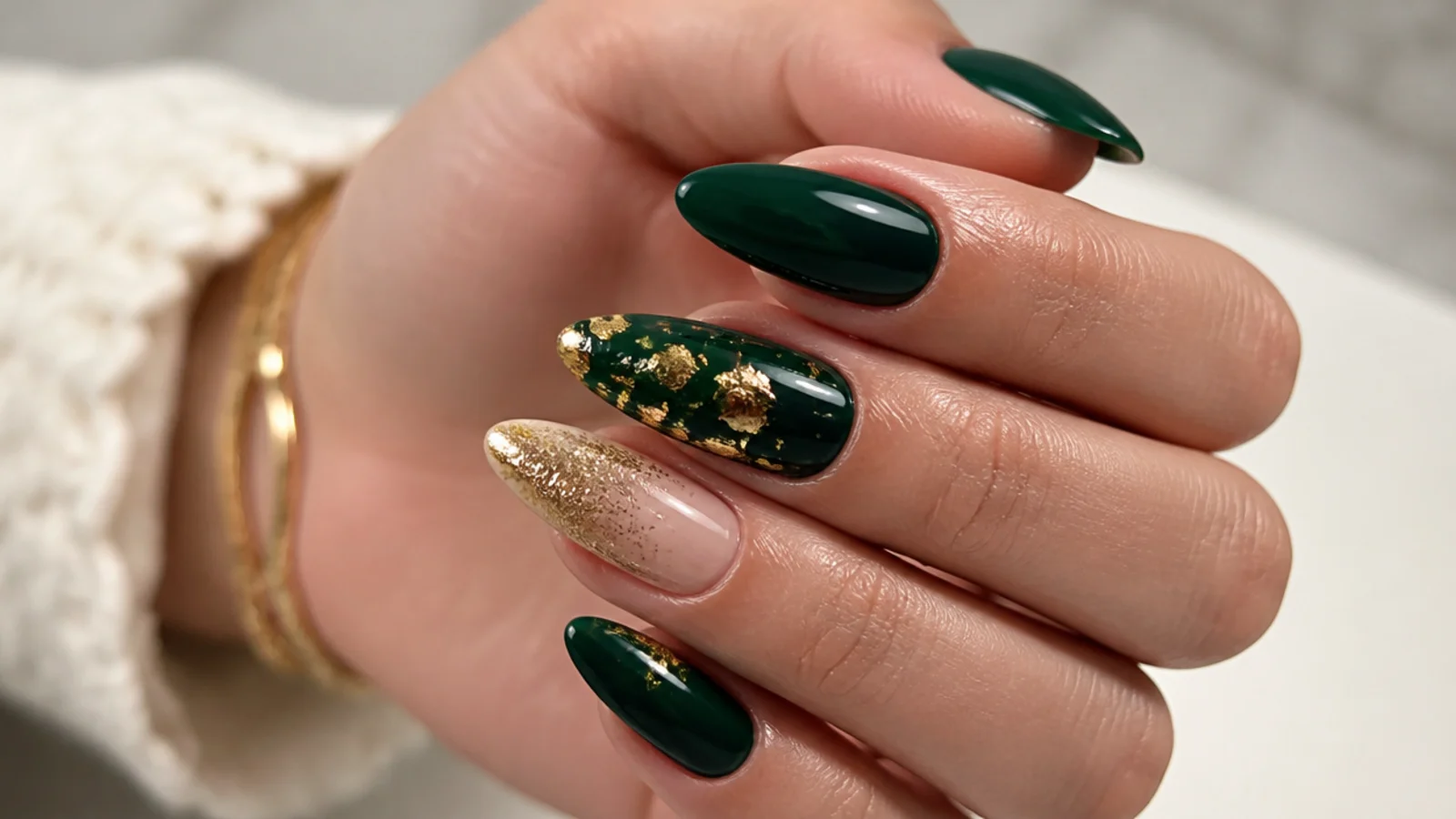 Deep emerald and gold nails styled for an evening event