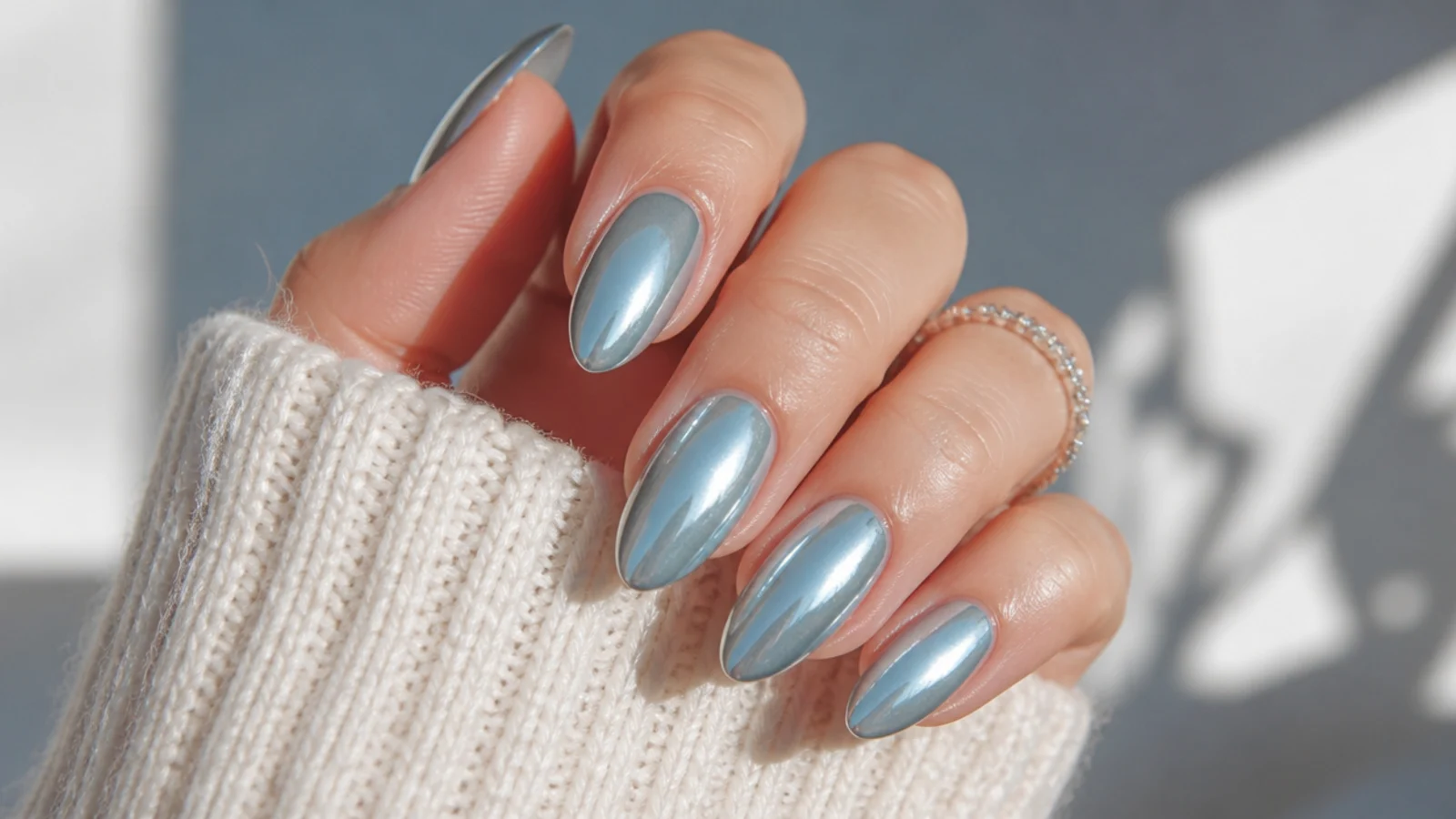Icy blue chrome almond December nails with a mirror finish