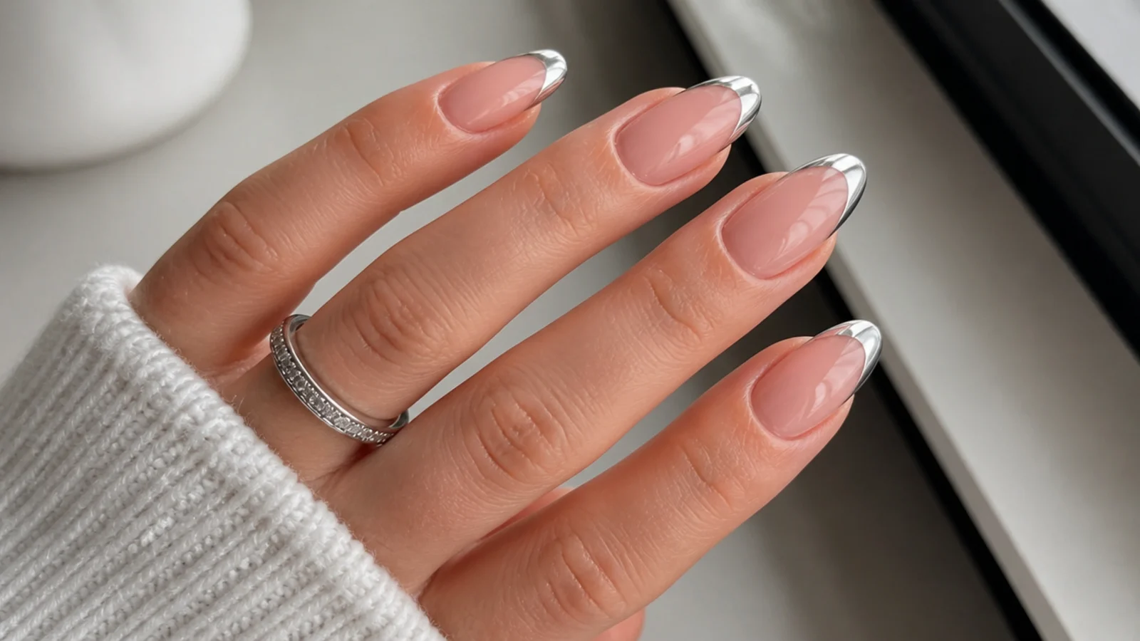 Nude almond December nails with mirror silver chrome French tips