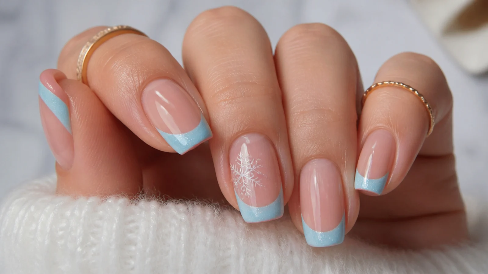 Icy baby blue French tip December nails on a clear nude base