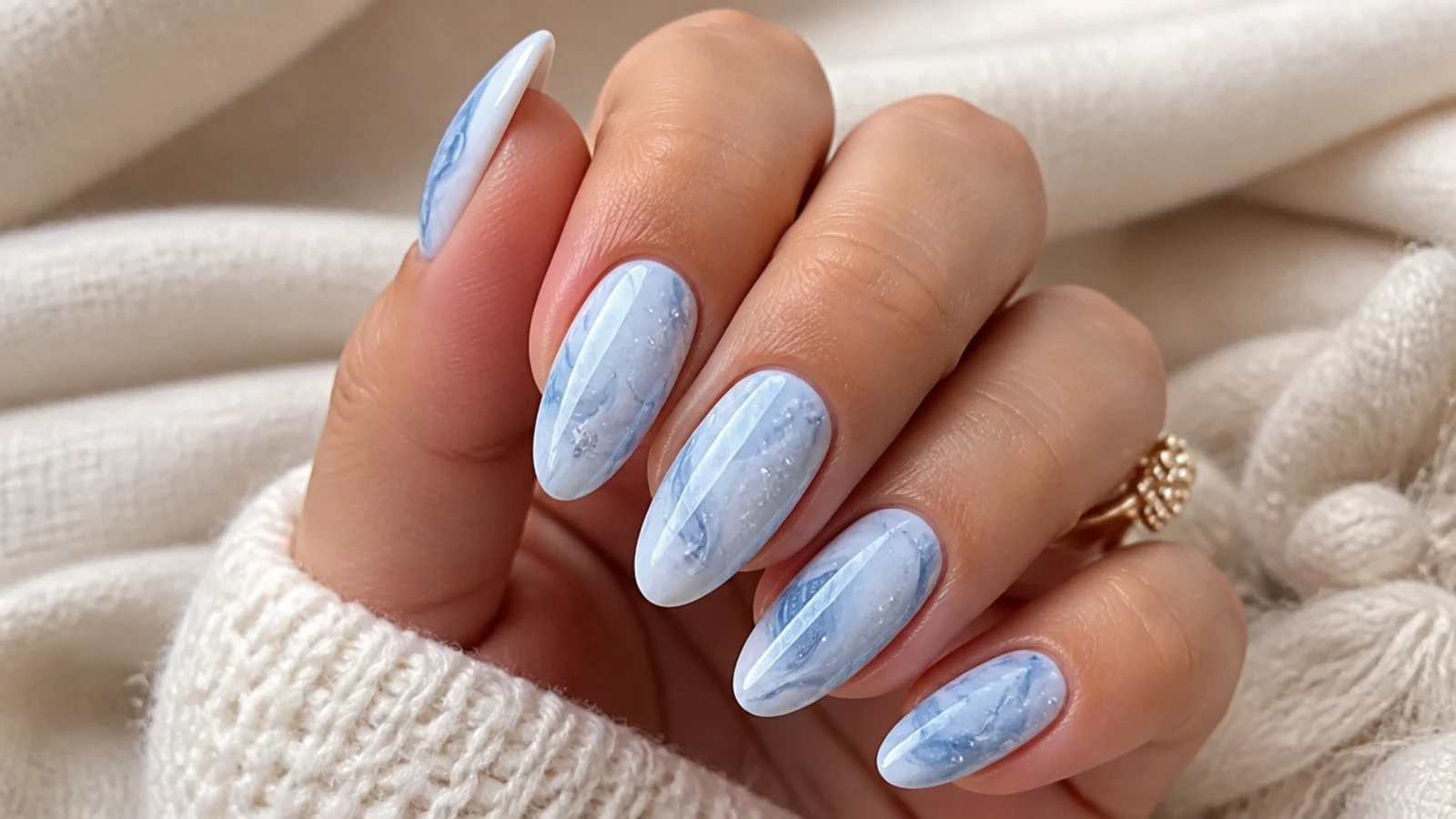 Icy blue and white swirl December nails with a marble effect
