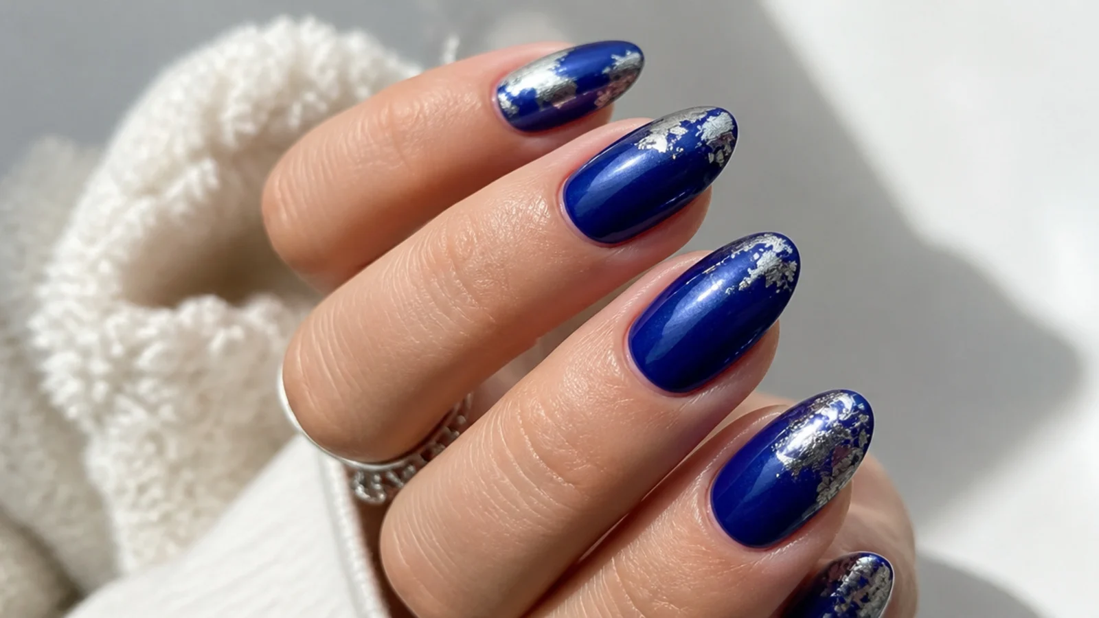 Royal blue December nails with cracked silver foil accents