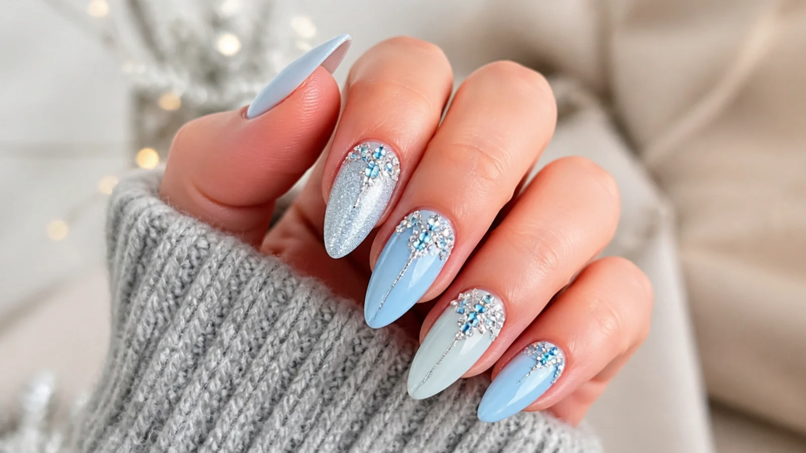 Icy blue December nails with clustered silver and blue rhinestones