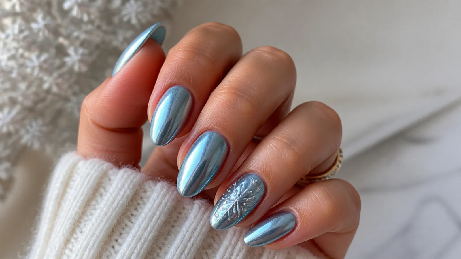 Icy blue chrome December birthday nails with silver reflective shine