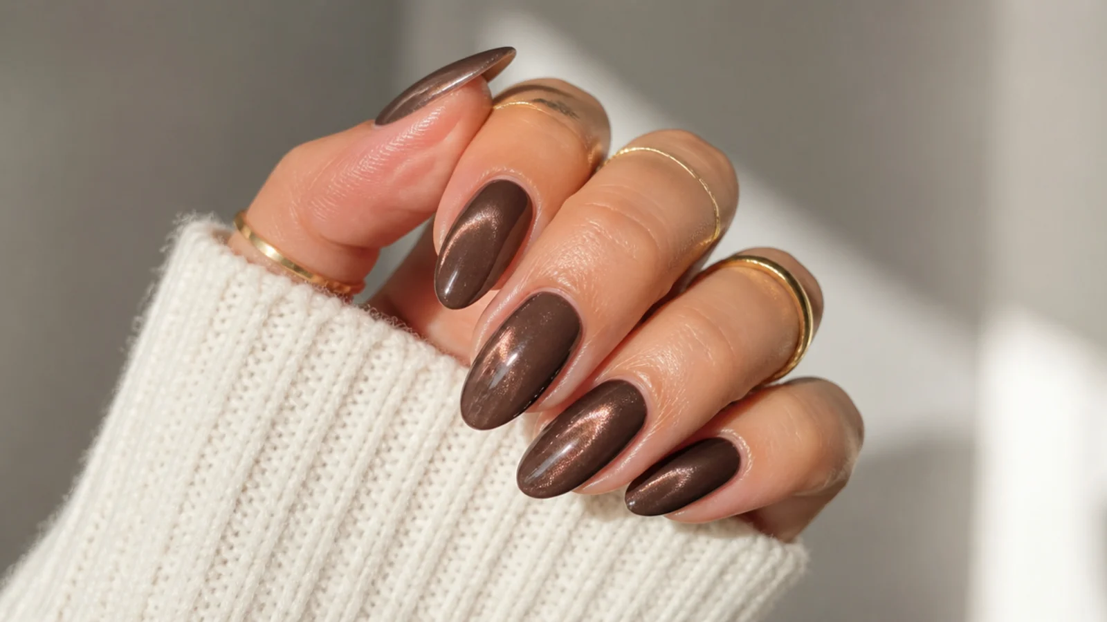 Glossy chocolate brown December nails with a glazed pearl top coat