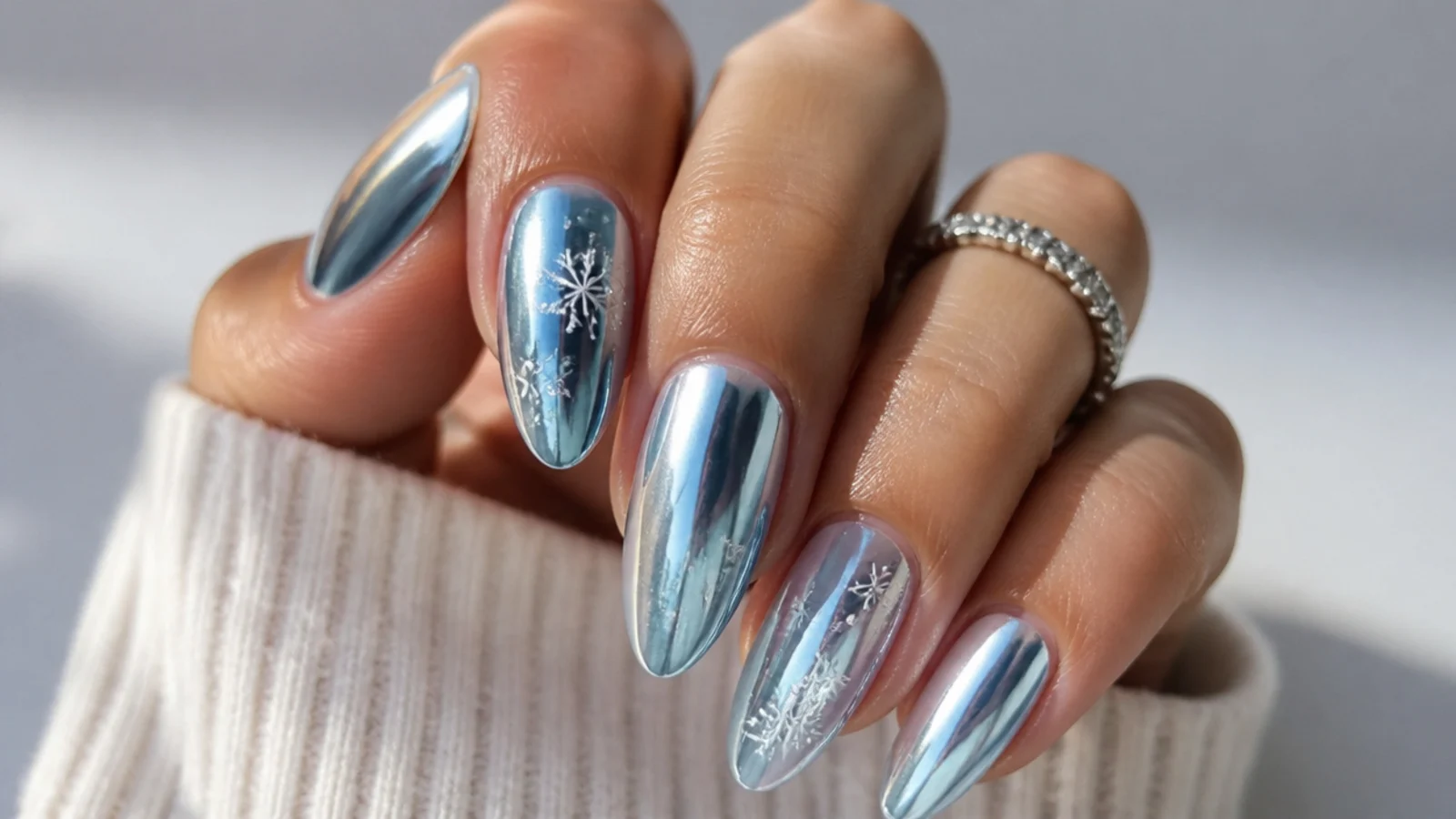 Frosty icy blue chrome December nails with a mirrored metallic finish