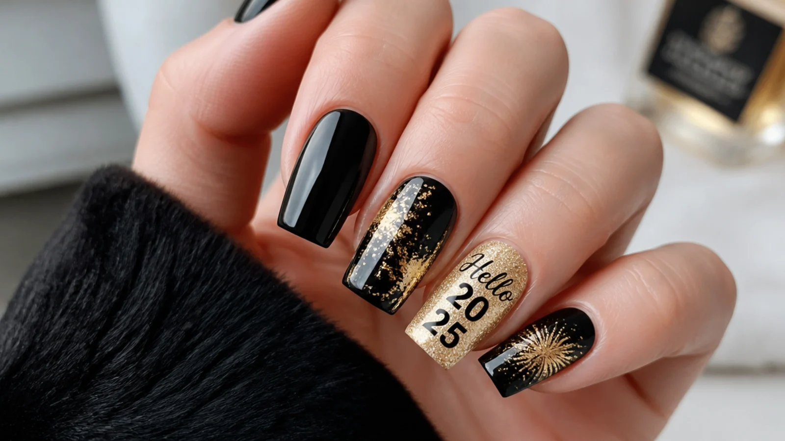 Glossy black December nails with gold foil and glitter New Year accents