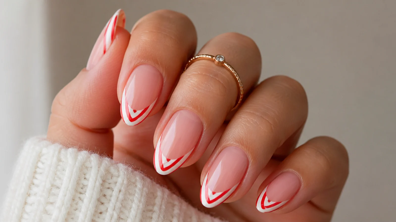 Red and white diagonal candy cane French tip December nails